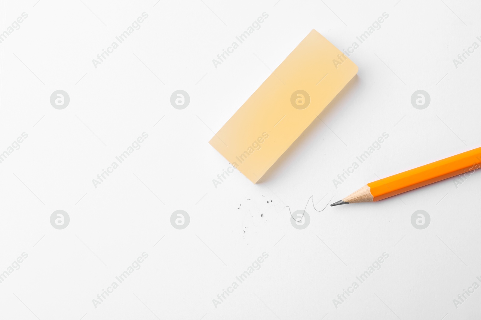 Pencil and eraser on white background, flat lay. Space for text Photo of Pencil and eraser on white background, flat lay. Space for text