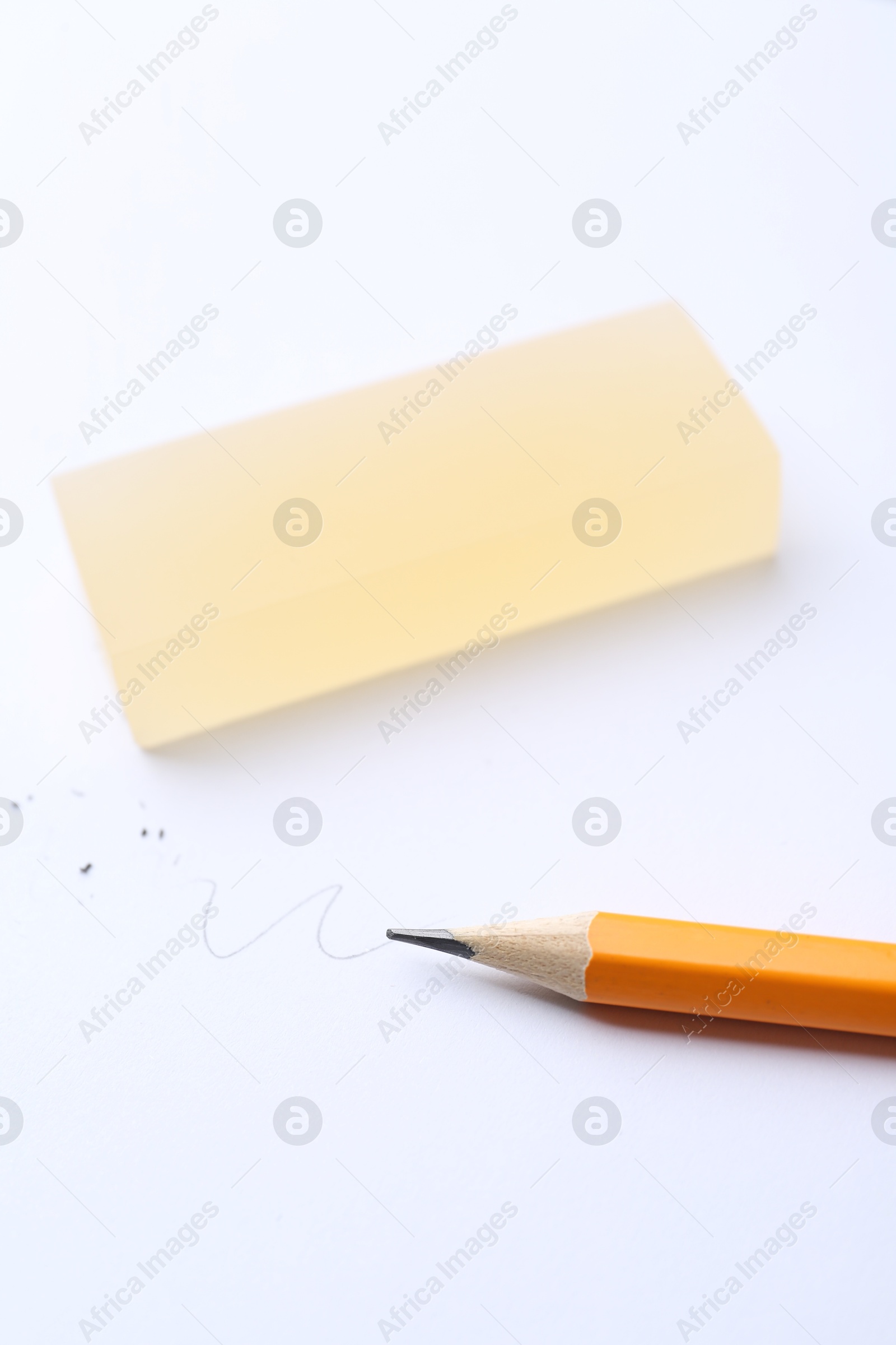 Photo of Pencil and eraser on white background, closeup