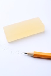 Photo of Pencil and eraser on white background, closeup