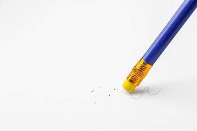 Photo of Using pencil with eraser on white background, closeup. Space for text