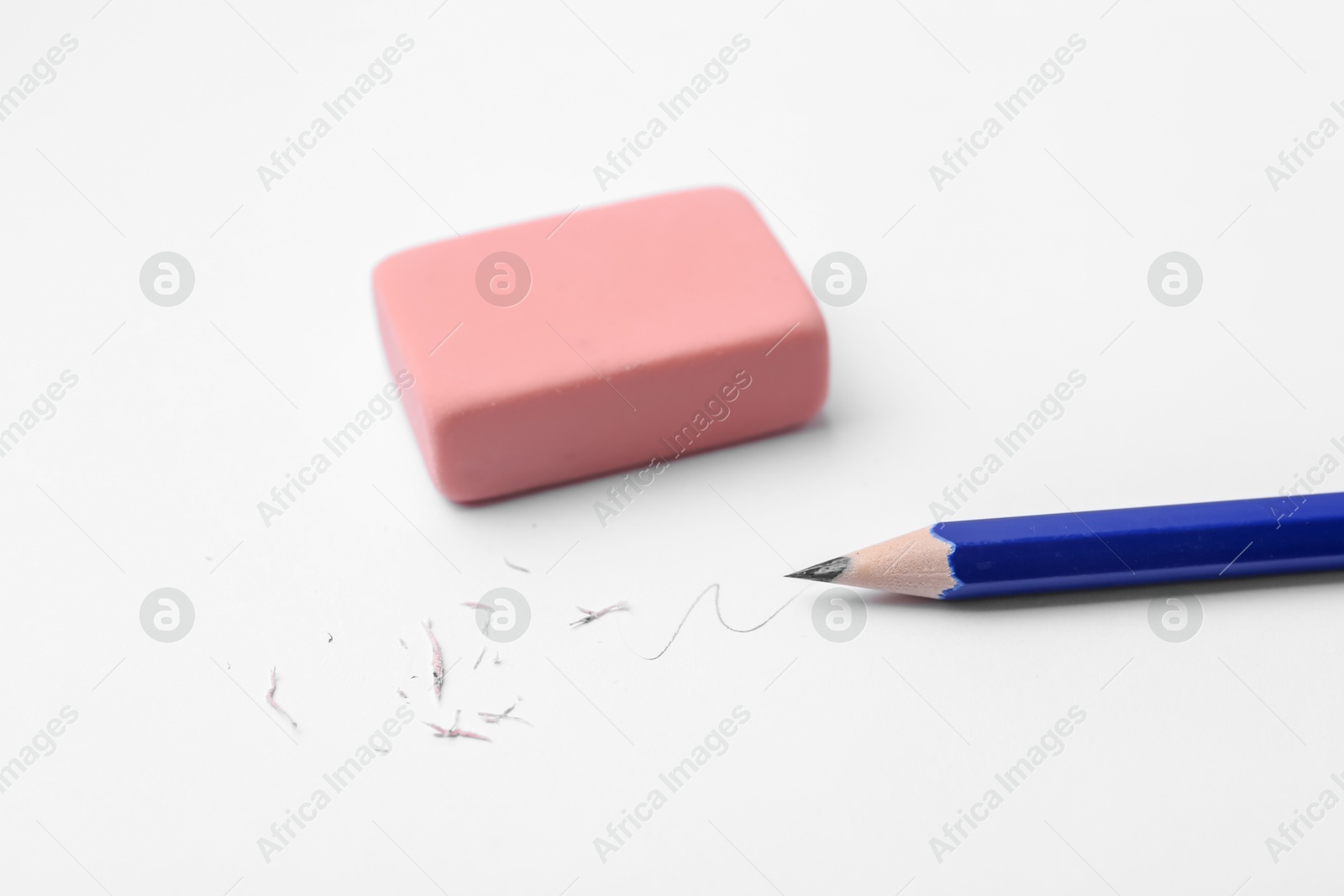 Pencil, eraser, doodle and scraps on white background, closeup Photo of Pencil, eraser, doodle and scraps on white background, closeup