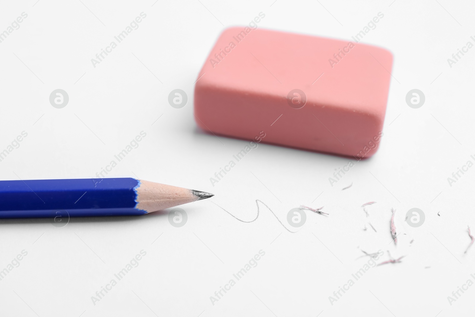 Pencil, eraser, doodle and scraps on white background, closeup Photo of Pencil, eraser, doodle and scraps on white background, closeup
