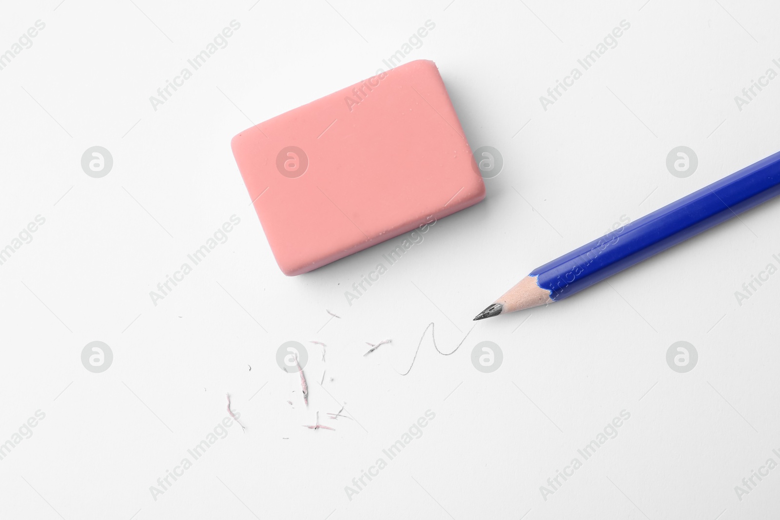 Pencil, eraser, doodle and scraps on white background, flat lay Photo of Pencil, eraser, doodle and scraps on white background, flat lay