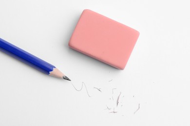 Photo of Pencil, eraser, doodle and scraps on white background, flat lay