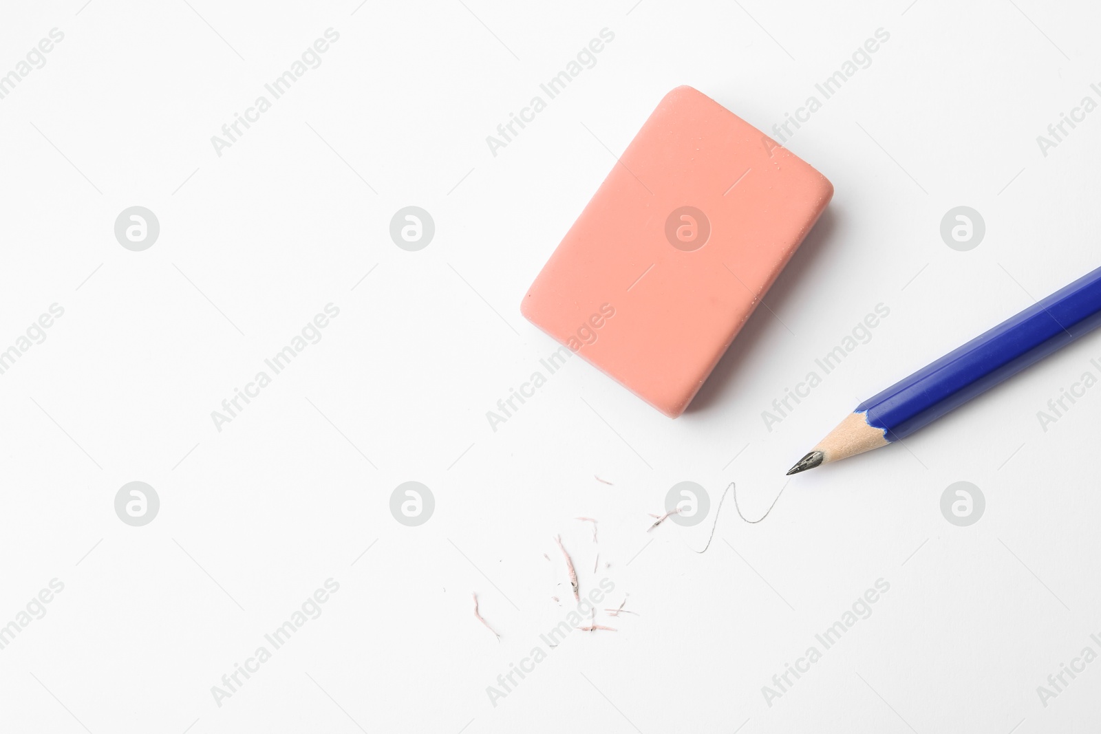 Pencil, eraser, doodle and scraps on white background, flat lay. Space for text Photo of Pencil, eraser, doodle and scraps on white background, flat lay. Space for text