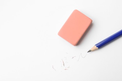 Photo of Pencil, eraser, doodle and scraps on white background, flat lay. Space for text
