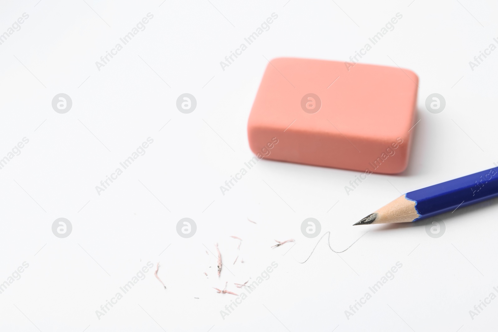 Pencil, eraser, doodle and scraps on white background, closeup. Space for text Photo of Pencil, eraser, doodle and scraps on white background, closeup. Space for text