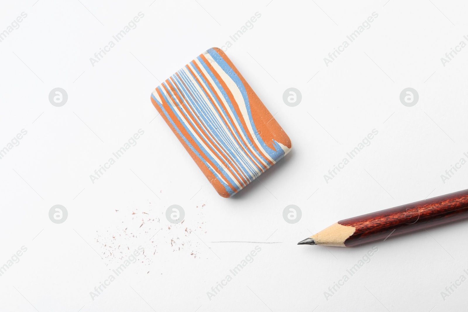 Pencil, eraser and scraps on white background, flat lay Photo of Pencil, eraser and scraps on white background, flat lay