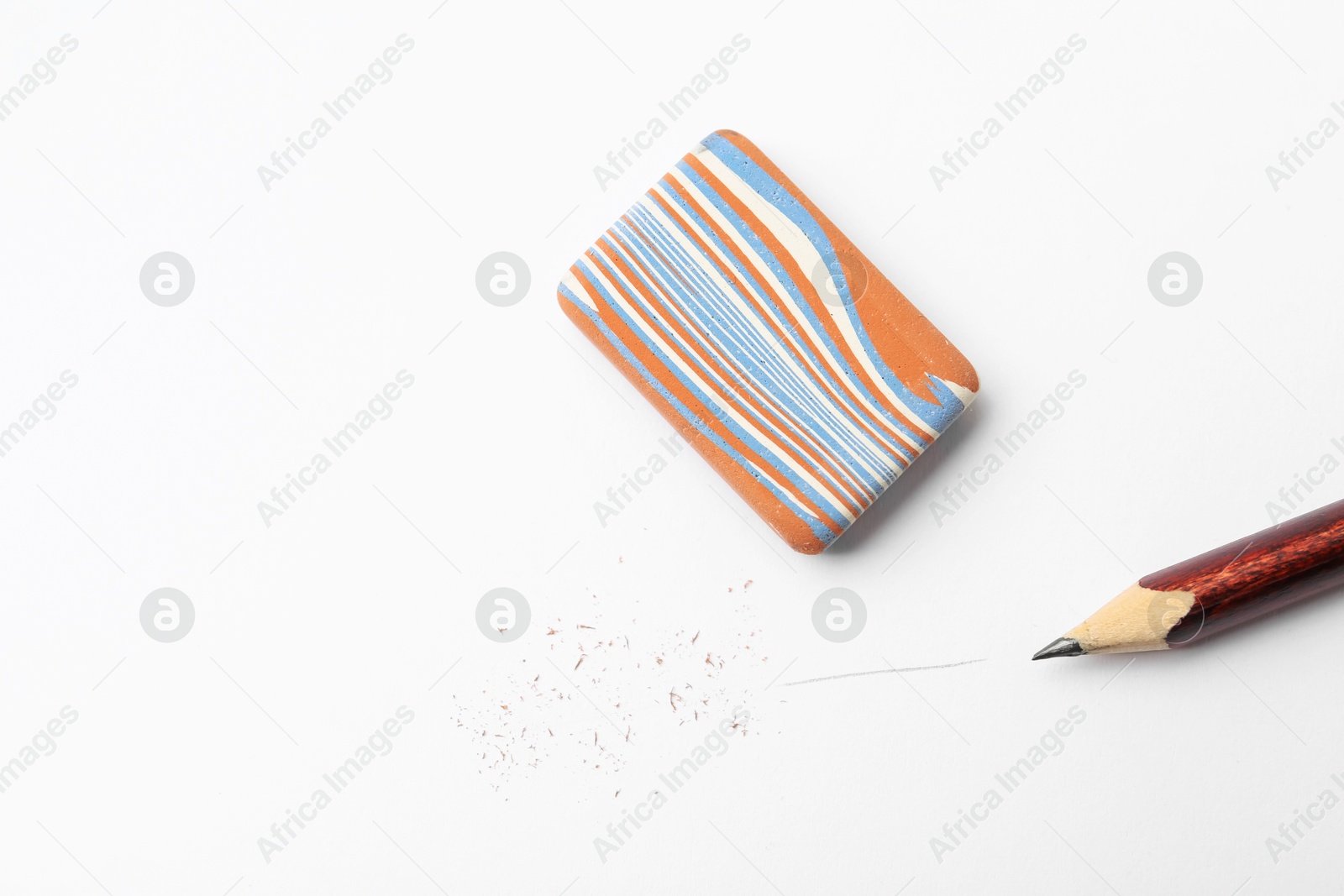 Pencil, eraser and scraps on white background, flat lay. Space for text Photo of Pencil, eraser and scraps on white background, flat lay. Space for text