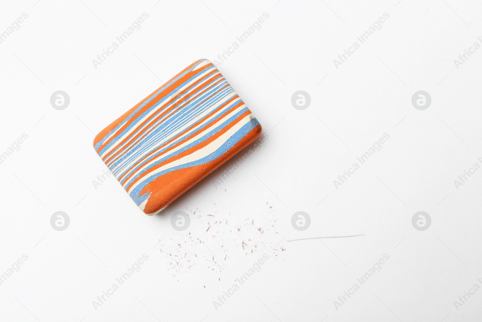 Photo of Eraser and scraps on white background, top view