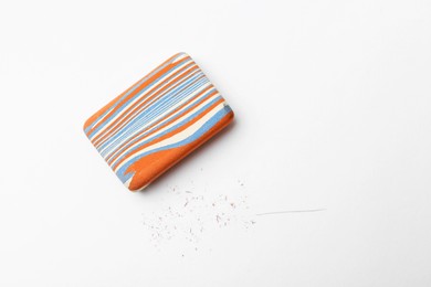 Photo of Eraser and scraps on white background, top view