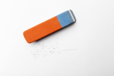 Photo of Eraser and scraps on white background, top view