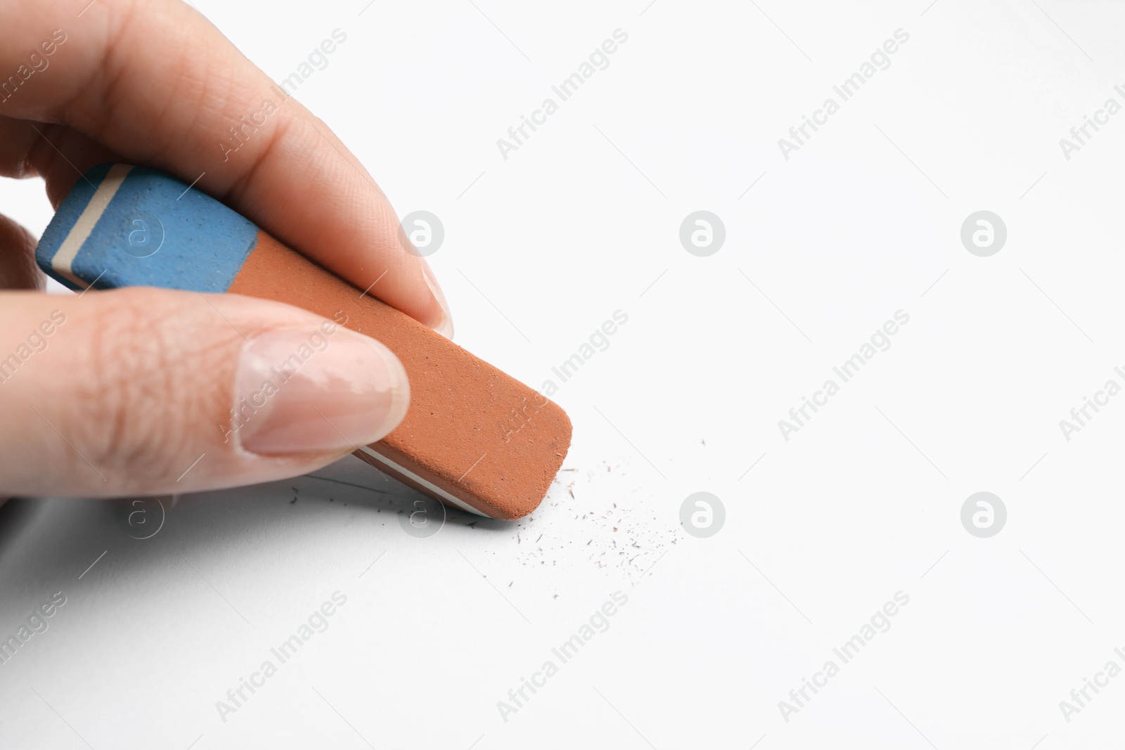 Woman using eraser at white paper, closeup. Space for text Photo of Woman using eraser at white paper, closeup. Space for text