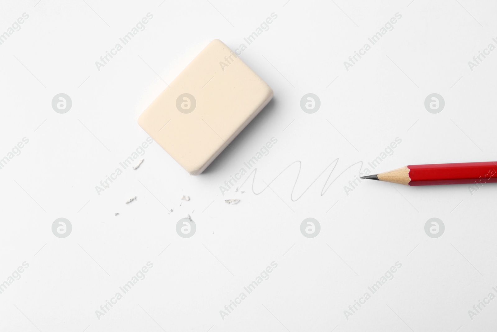 Pencil, eraser, doodle and scraps on white background, flat lay Photo of Pencil, eraser, doodle and scraps on white background, flat lay