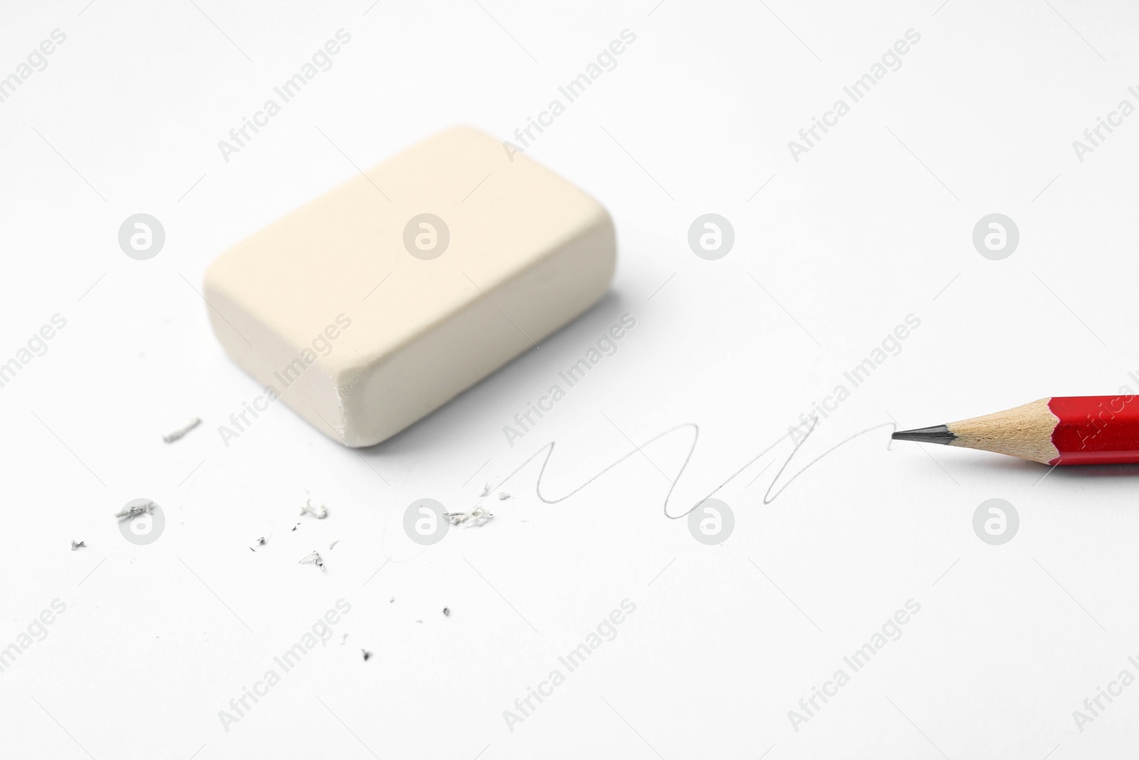 Pencil, eraser, doodle and scraps on white background, closeup Photo of Pencil, eraser, doodle and scraps on white background, closeup