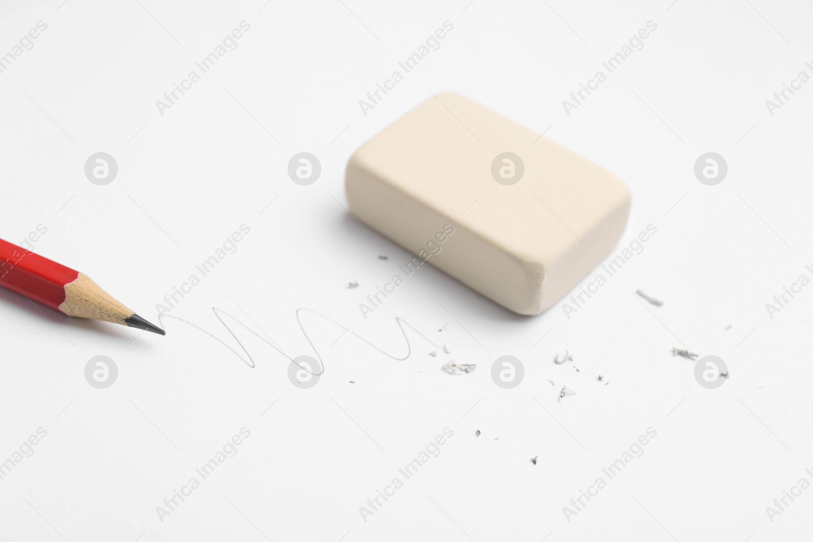 Pencil, eraser, doodle and scraps on white background, closeup Photo of Pencil, eraser, doodle and scraps on white background, closeup