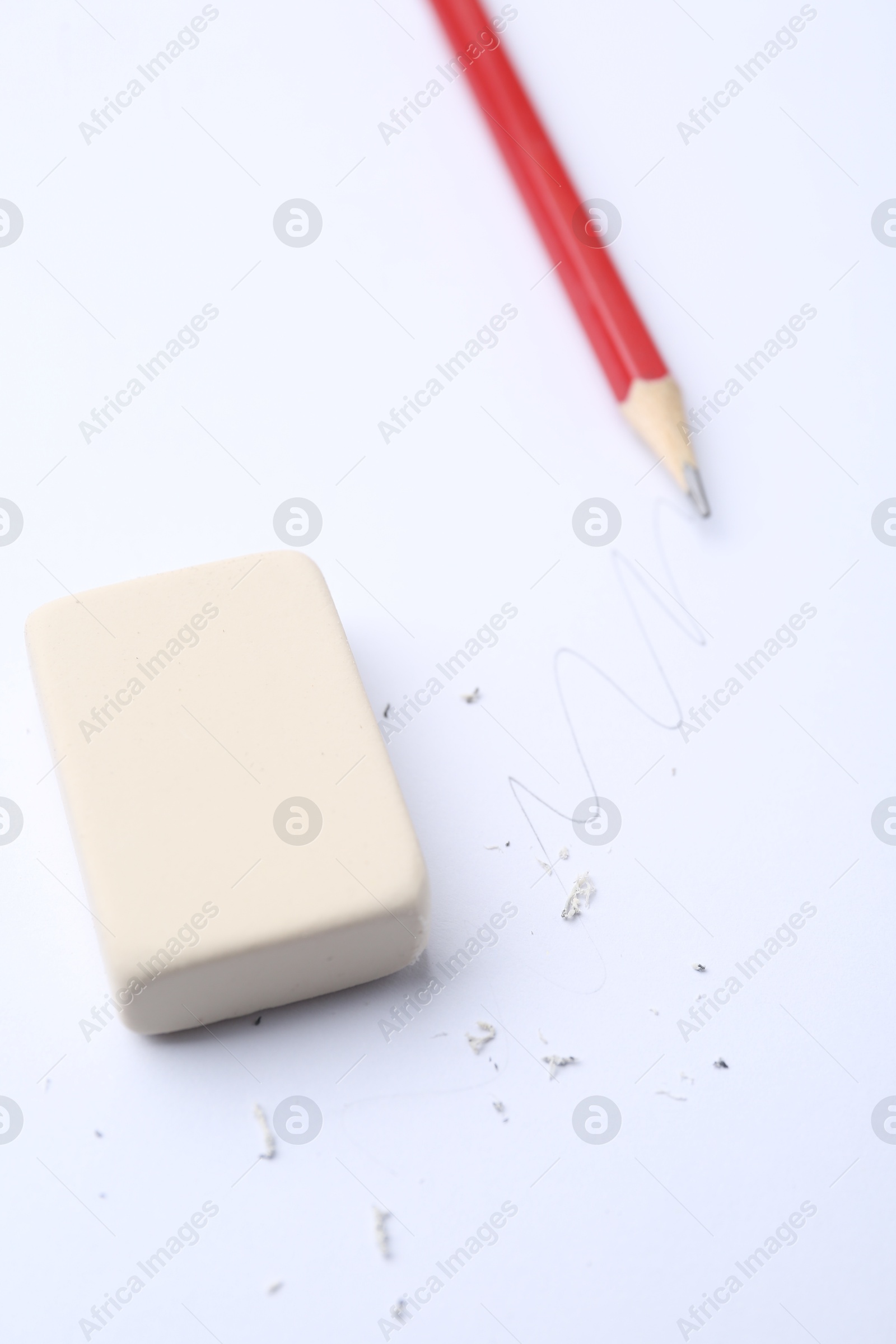 Eraser, pencil, doodle and scraps on white background, selective focus Photo of Eraser, pencil, doodle and scraps on white background, selective focus