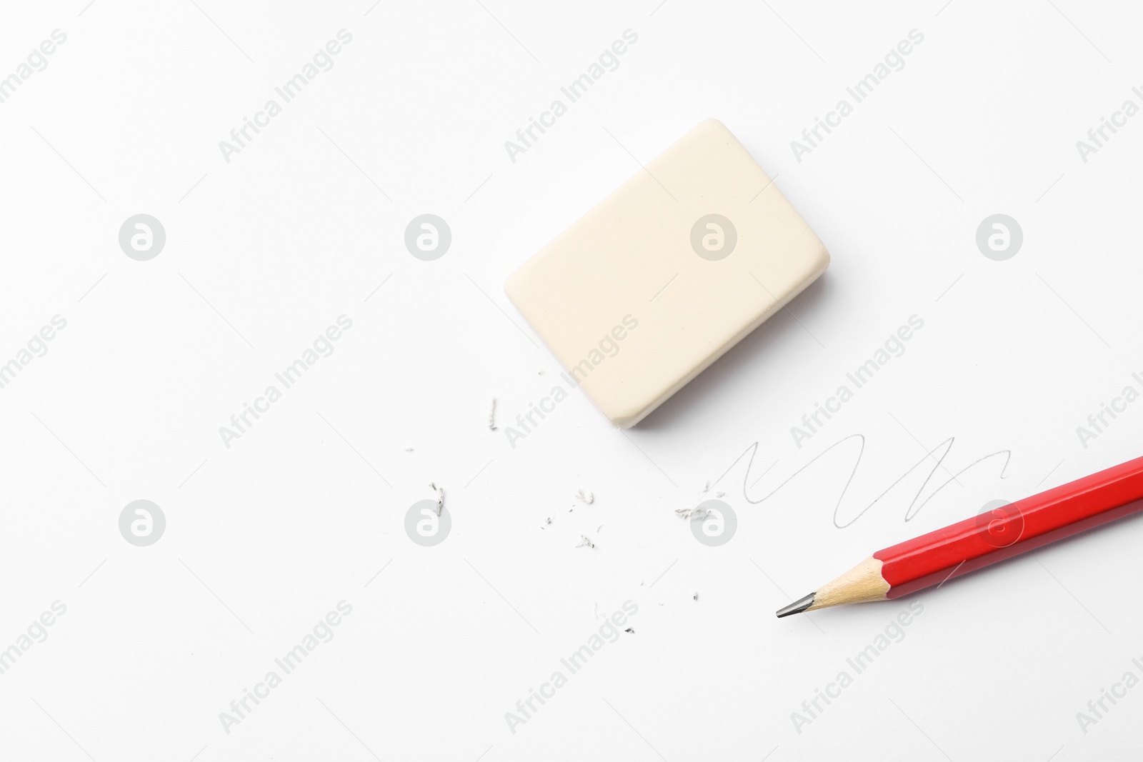 Pencil, eraser, doodle and scraps on white background, flat lay. Space for text Photo of Pencil, eraser, doodle and scraps on white background, flat lay. Space for text