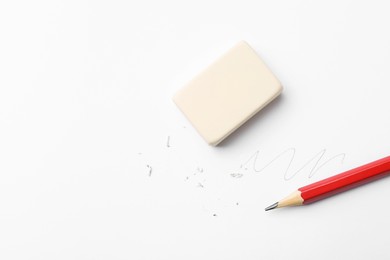 Photo of Pencil, eraser, doodle and scraps on white background, flat lay. Space for text