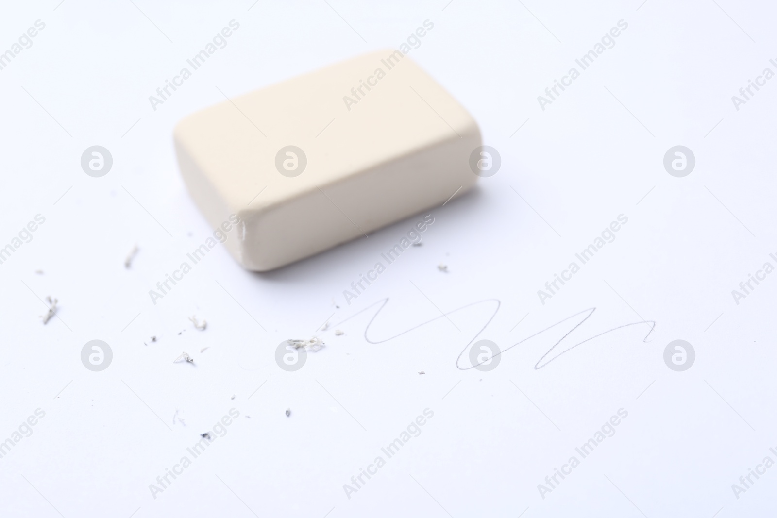 Eraser, doodle and scraps on white background, selective focus Photo of Eraser, doodle and scraps on white background, selective focus