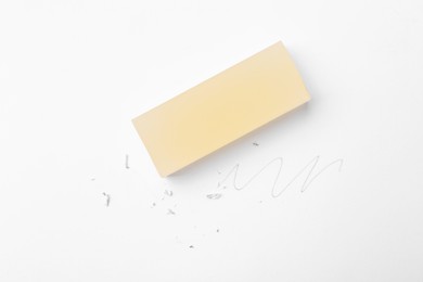 Photo of Eraser, doodle and scraps on white background, top view