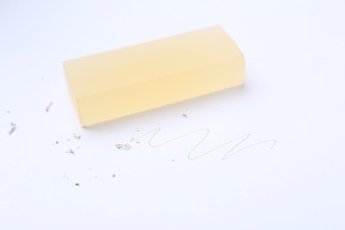 Photo of Eraser, doodle and scraps on white background, selective focus
