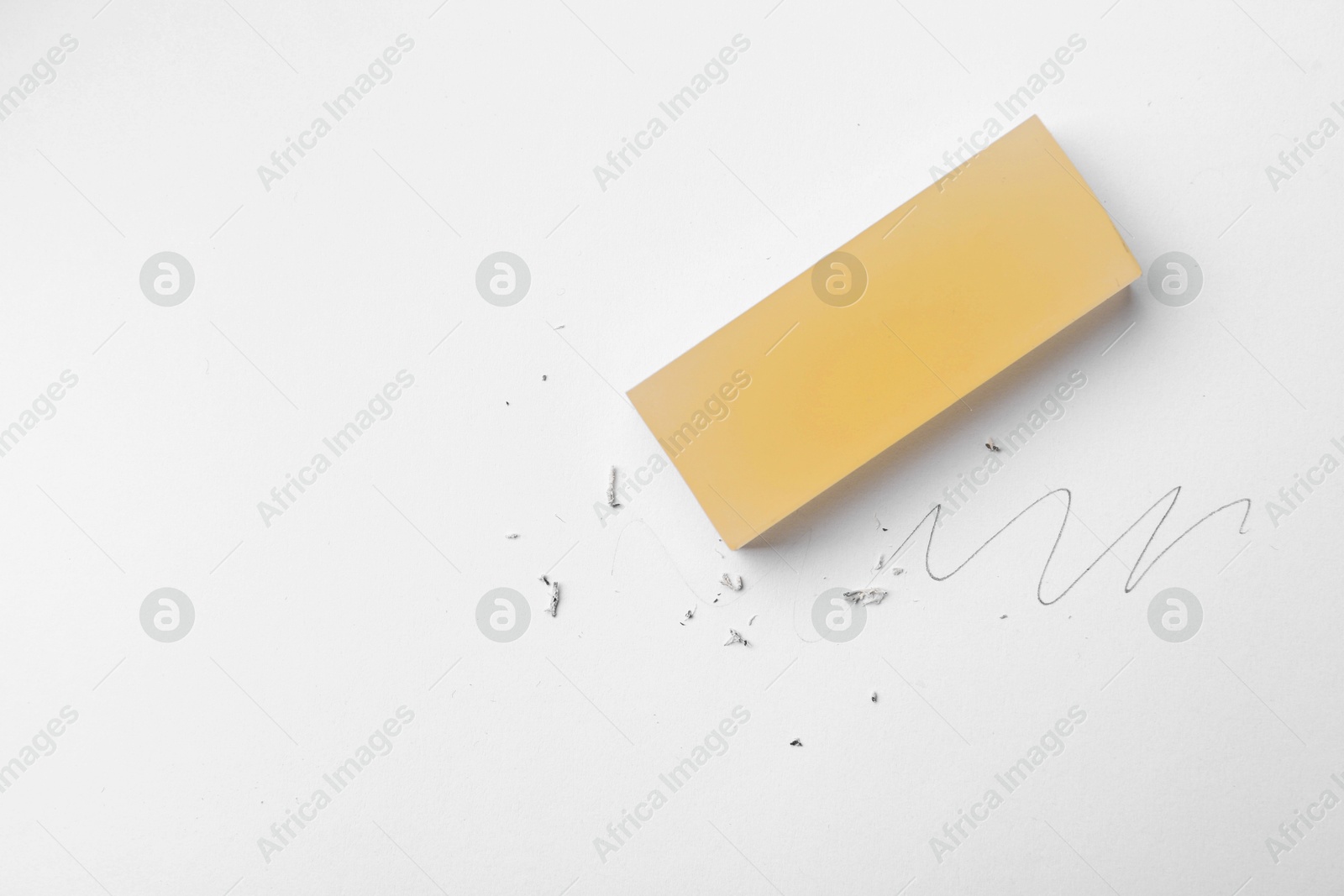Eraser, doodle and scraps on white background, top view. Space for text Photo of Eraser, doodle and scraps on white background, top view. Space for text