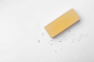 Photo of Eraser, doodle and scraps on white background, top view. Space for text