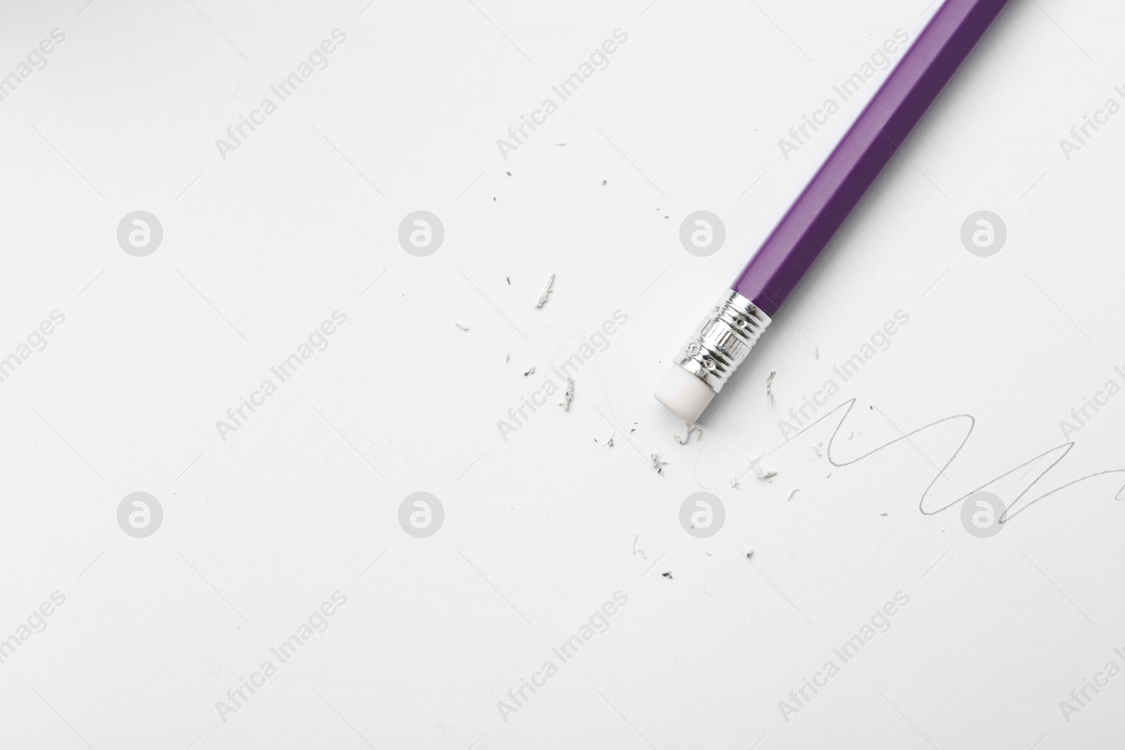 Pencil with eraser, doodle and scraps on white background, top view. Space for text Photo of Pencil with eraser, doodle and scraps on white background, top view. Space for text