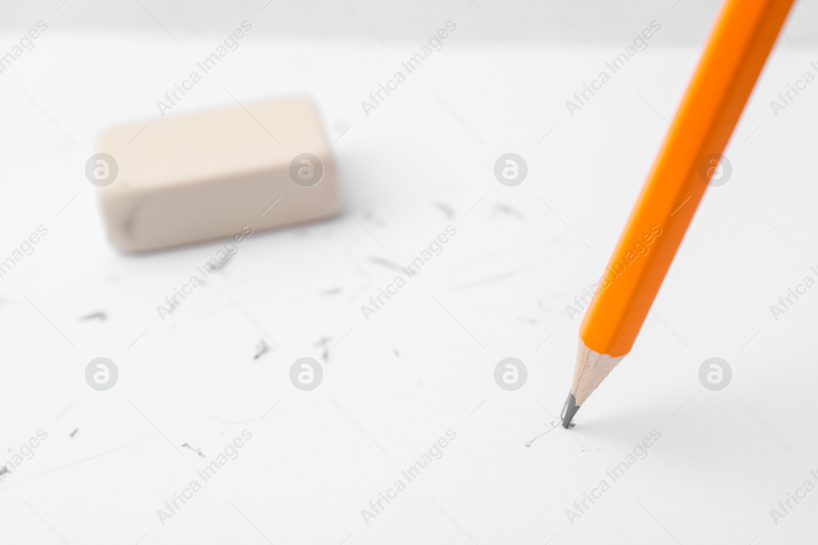 Graphite pencil and eraser on paper sheet, closeup Photo of Graphite pencil and eraser on paper sheet, closeup