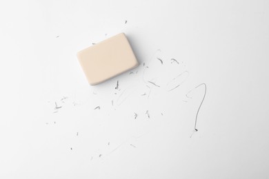 Photo of Eraser on paper sheet with pencil strokes, top view