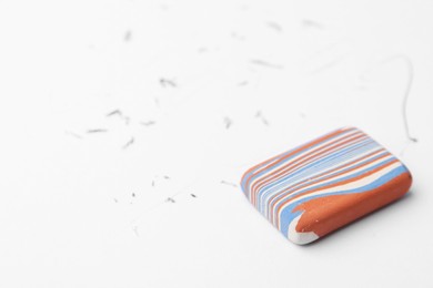 Photo of Eraser on paper sheet with pencil strokes, closeup