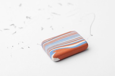 Photo of Eraser on paper sheet with pencil strokes, closeup