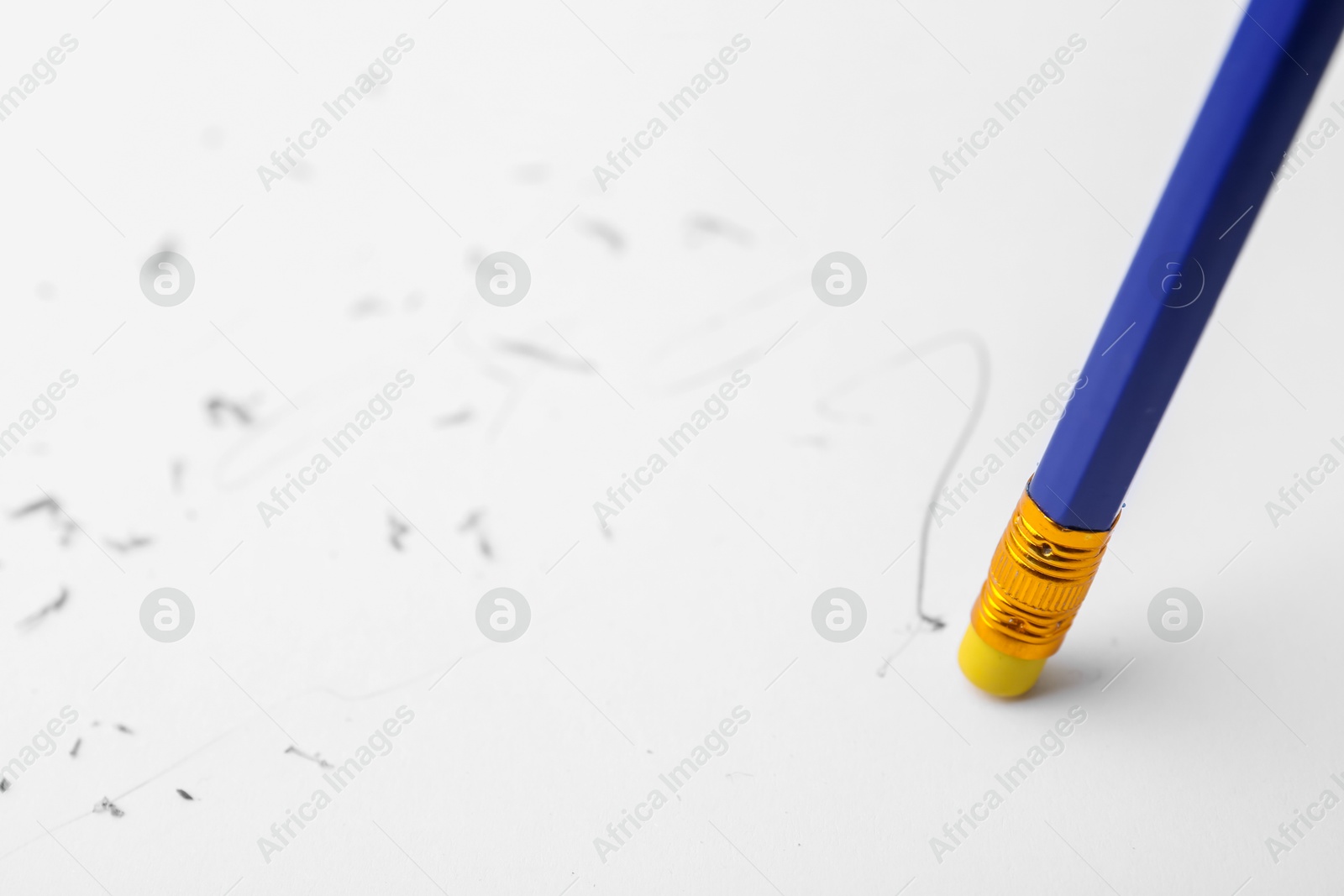 Graphite pencil with eraser on paper sheet, closeup Photo of Graphite pencil with eraser on paper sheet, closeup