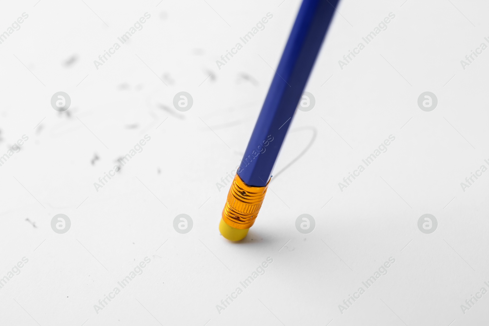 Graphite pencil with eraser on paper sheet, closeup Photo of Graphite pencil with eraser on paper sheet, closeup