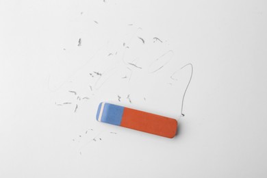 Photo of Eraser on paper sheet with pencil strokes, top view
