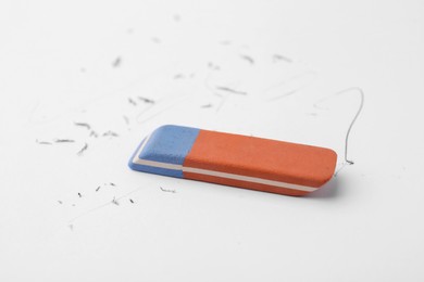Photo of Eraser on paper sheet with pencil strokes, closeup