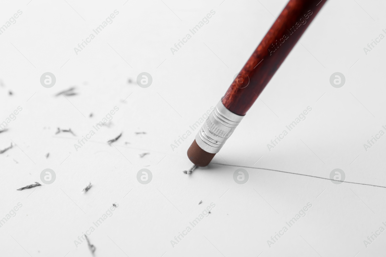 Graphite pencil with eraser on paper sheet, closeup Photo of Graphite pencil with eraser on paper sheet, closeup