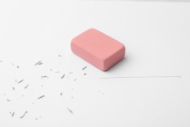 Photo of Eraser on paper sheet with pencil strokes, closeup
