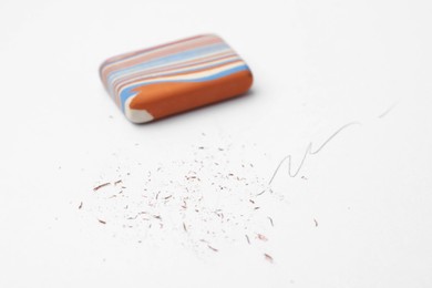 Photo of Eraser on paper sheet with pencil strokes, closeup
