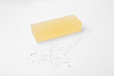 Photo of Eraser on paper sheet with pencil strokes, closeup