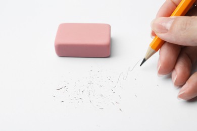 Photo of Woman drawing on paper with graphite pencil, closeup