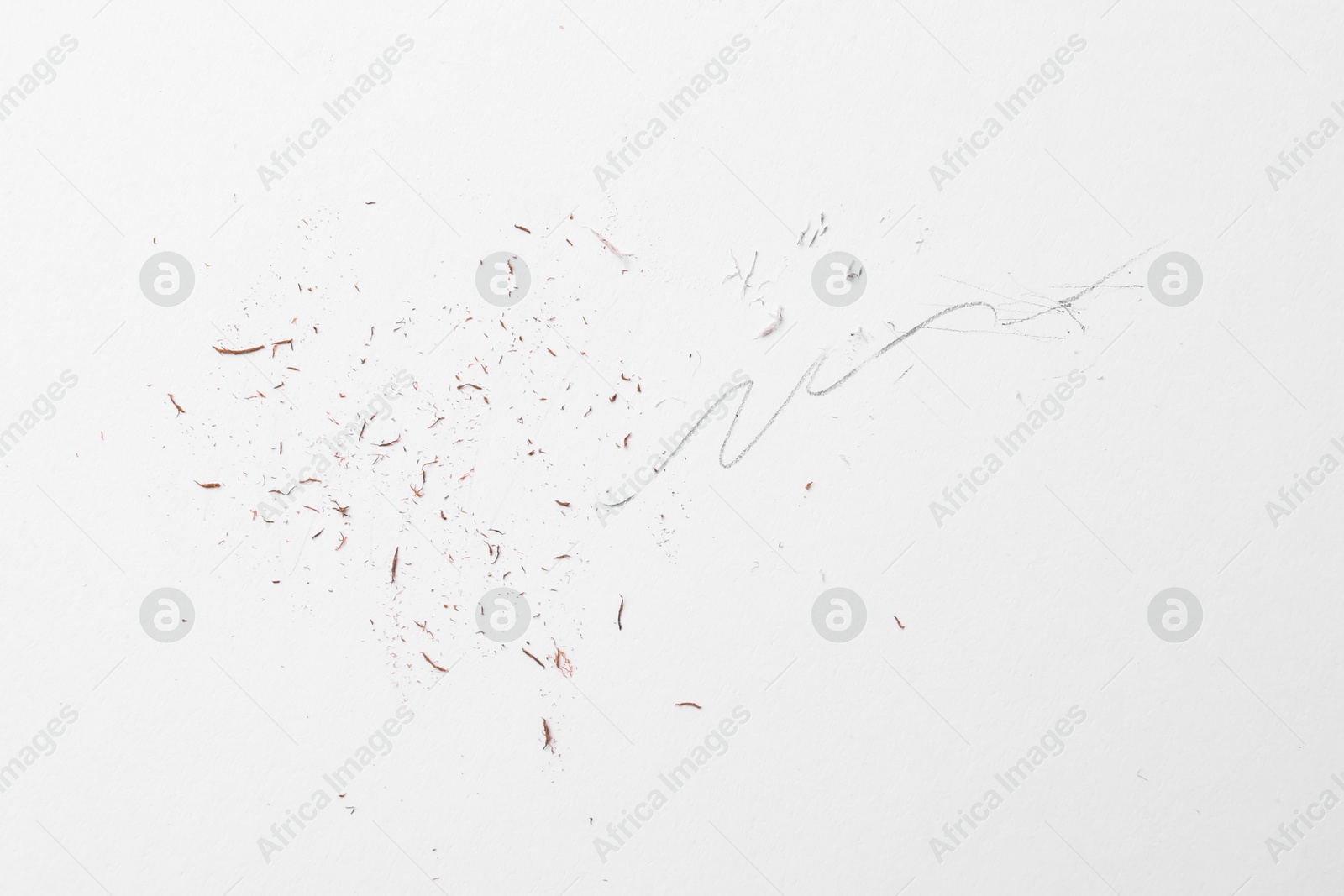 Graphite pencil strokes and eraser shavings on paper sheet, top view Photo of Graphite pencil strokes and eraser shavings on paper sheet, top view