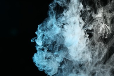 Photo of Beautiful hookah smoke on black background, closeup