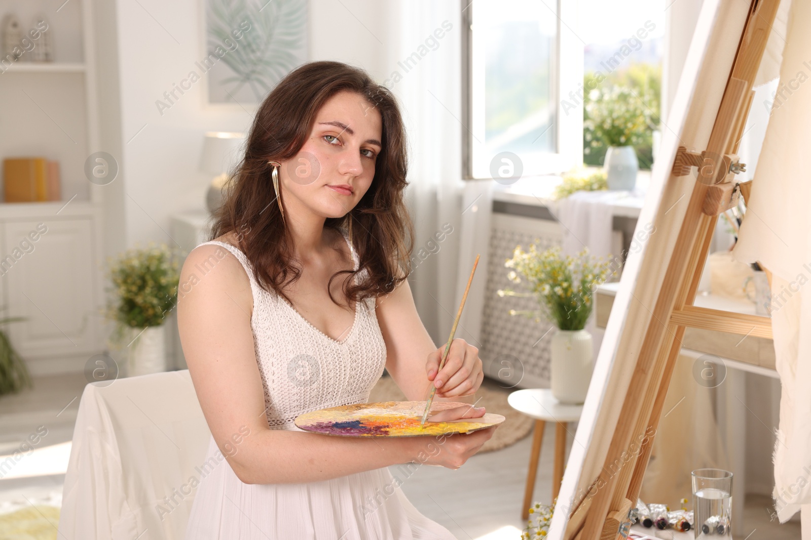 Beautiful woman drawing on canvas at home Photo of Beautiful woman drawing on canvas at home
