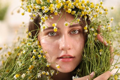 Photo of Portrait of beautiful woman with chamomile flowers, closeup