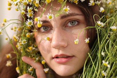 Photo of Portrait of beautiful woman with chamomile flowers, closeup
