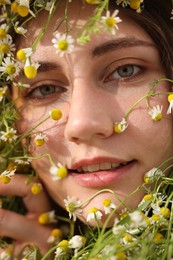 Photo of Portrait of beautiful woman with chamomile flowers, closeup