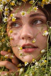 Photo of Portrait of beautiful woman with chamomile flowers, closeup