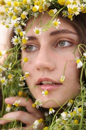Photo of Portrait of beautiful woman with chamomile flowers, closeup
